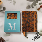 Brown and copper swirl fabric notebook displayed with the signature light blue window-cut gift box and wax seal stamp