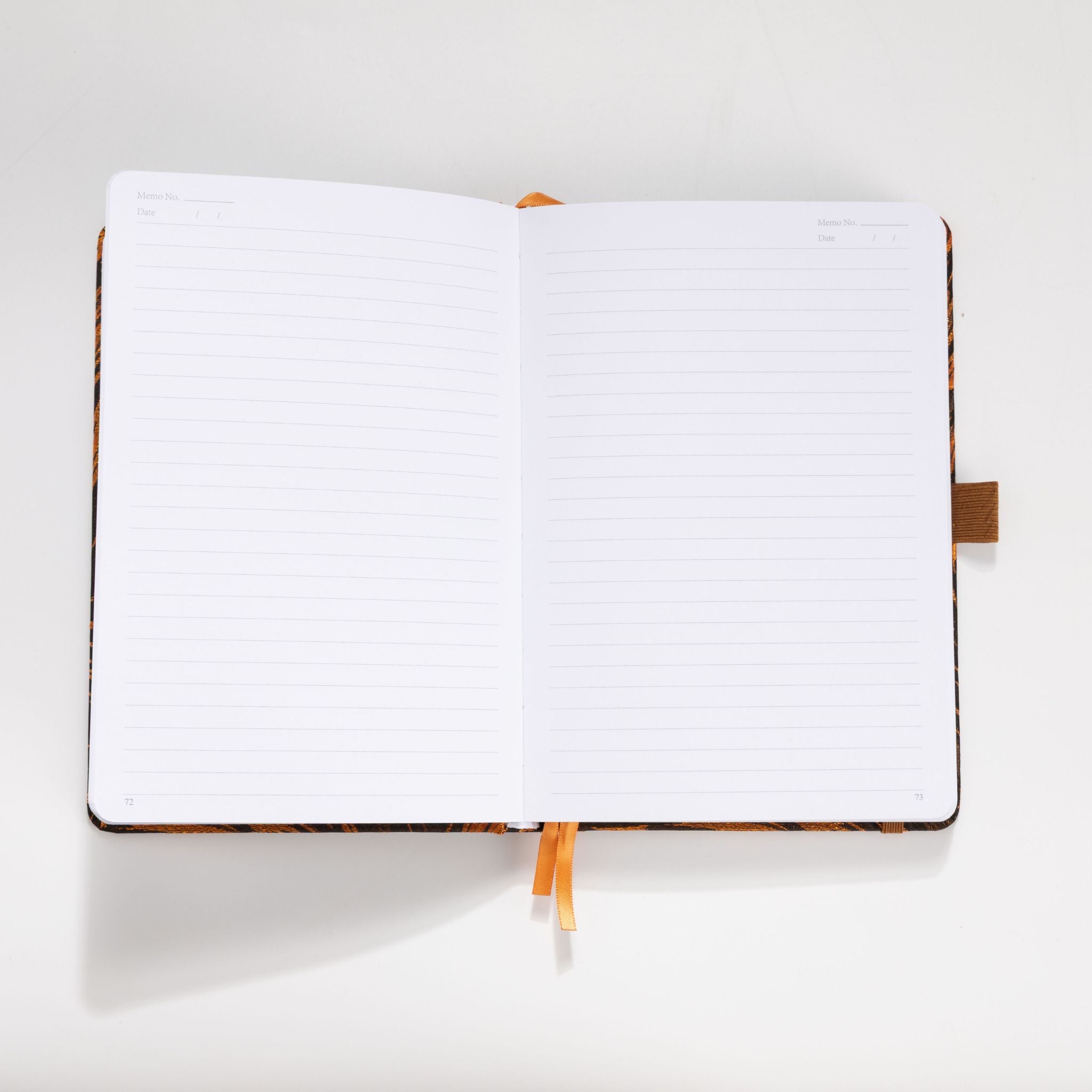 Open A5 notebook showing the 100gsm lined paper interior with memo and date headers