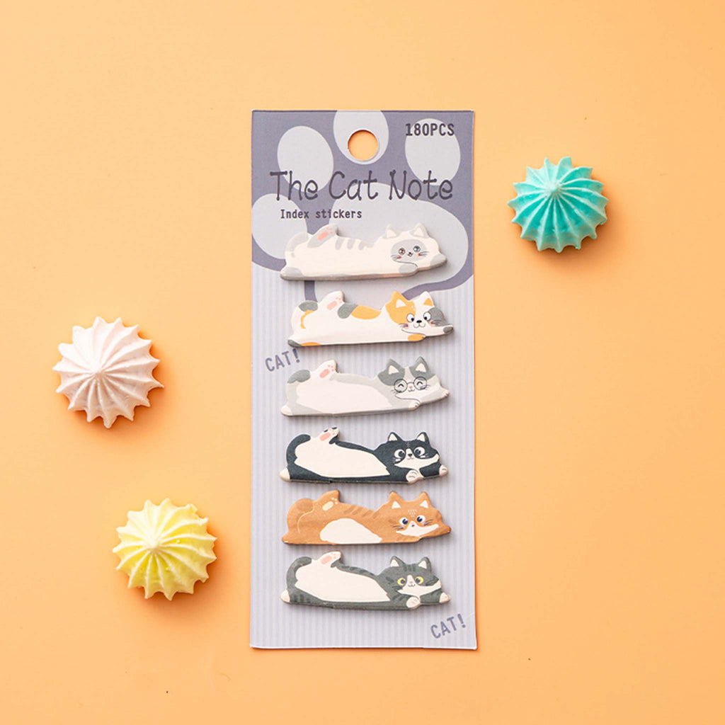 A package of six cat-themed sticky notes labeled 'The Cat Note' on a light peach background, styled with three decorative paper starburst props in white, yellow, and teal.