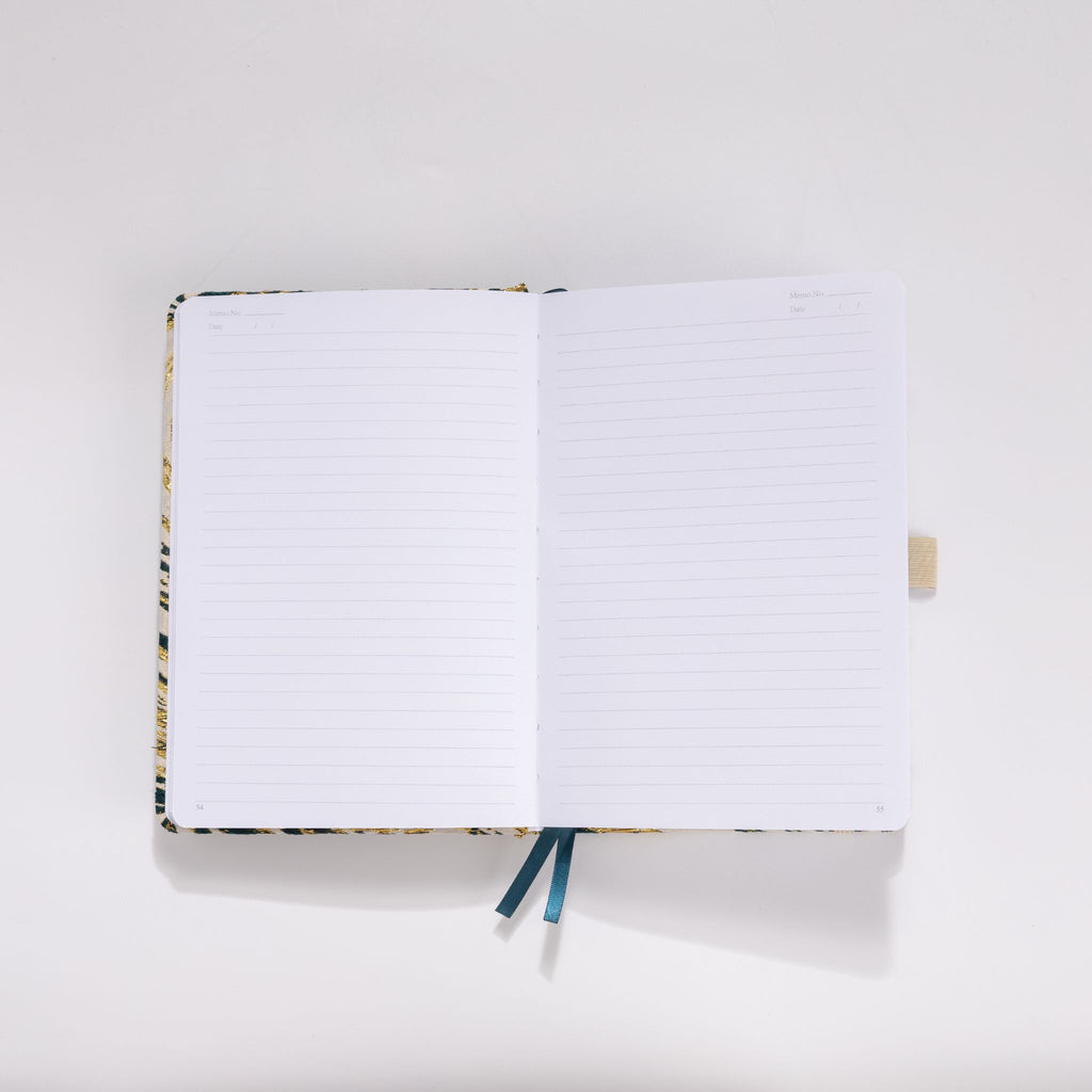 Open A5 notebook showing the 100gsm lined paper interior with date headers