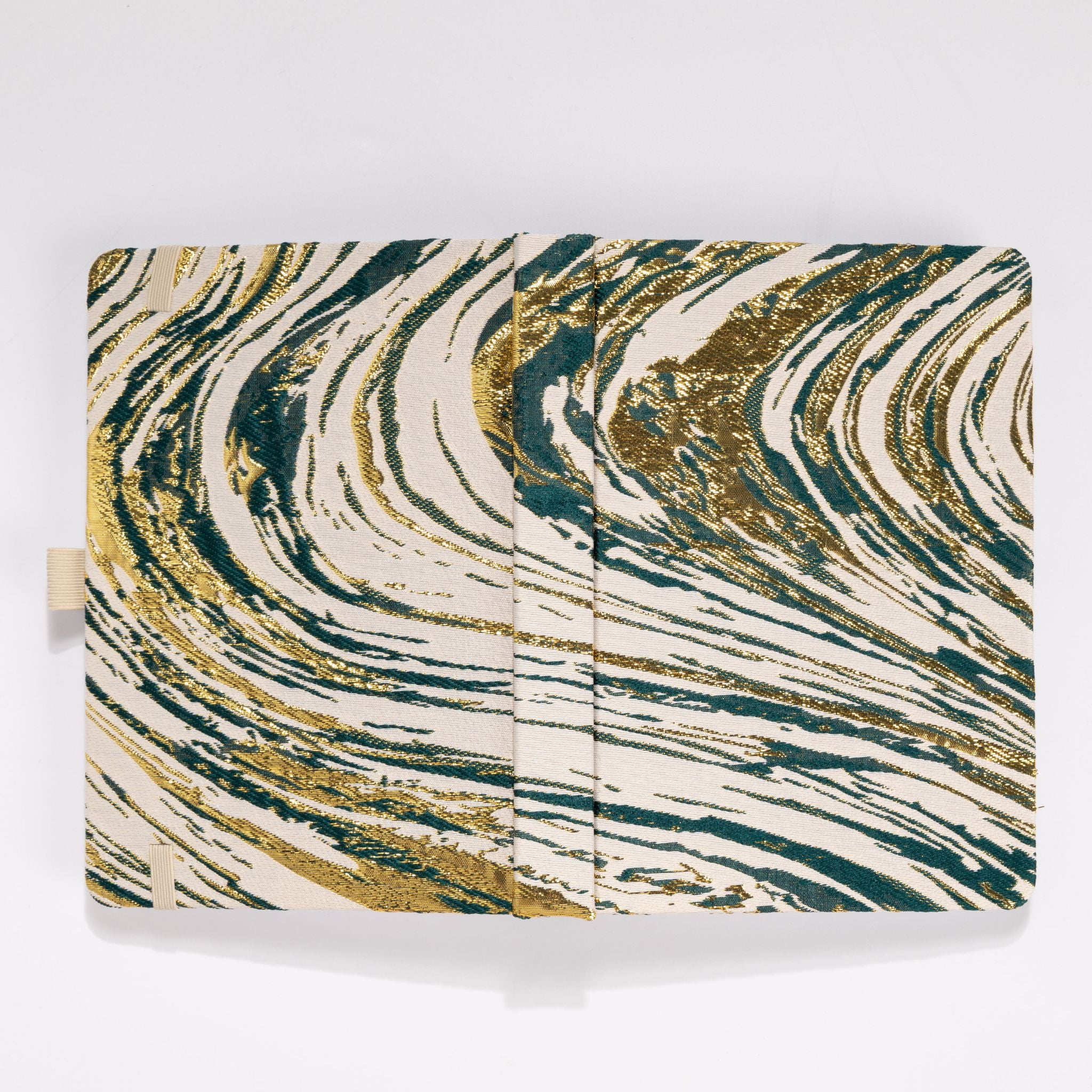 Flat lay of the dark green and gold marble woven fabric cover opened completely