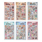 Six Everyday Life watercolor PET sticker themes displayed in hang-hole OPP packaging, featuring the designs Sweet Dreamland, Snack Journal, Travel List, Journey Wonders, Colored Universe, and Fragrance Notes.
