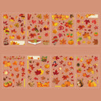 The Song of Dusk theme from the Forest Song gold foil PET sticker collection, displayed in its hang-hole OPP packaging with warm autumn tones, pinecones, and a rustic background.