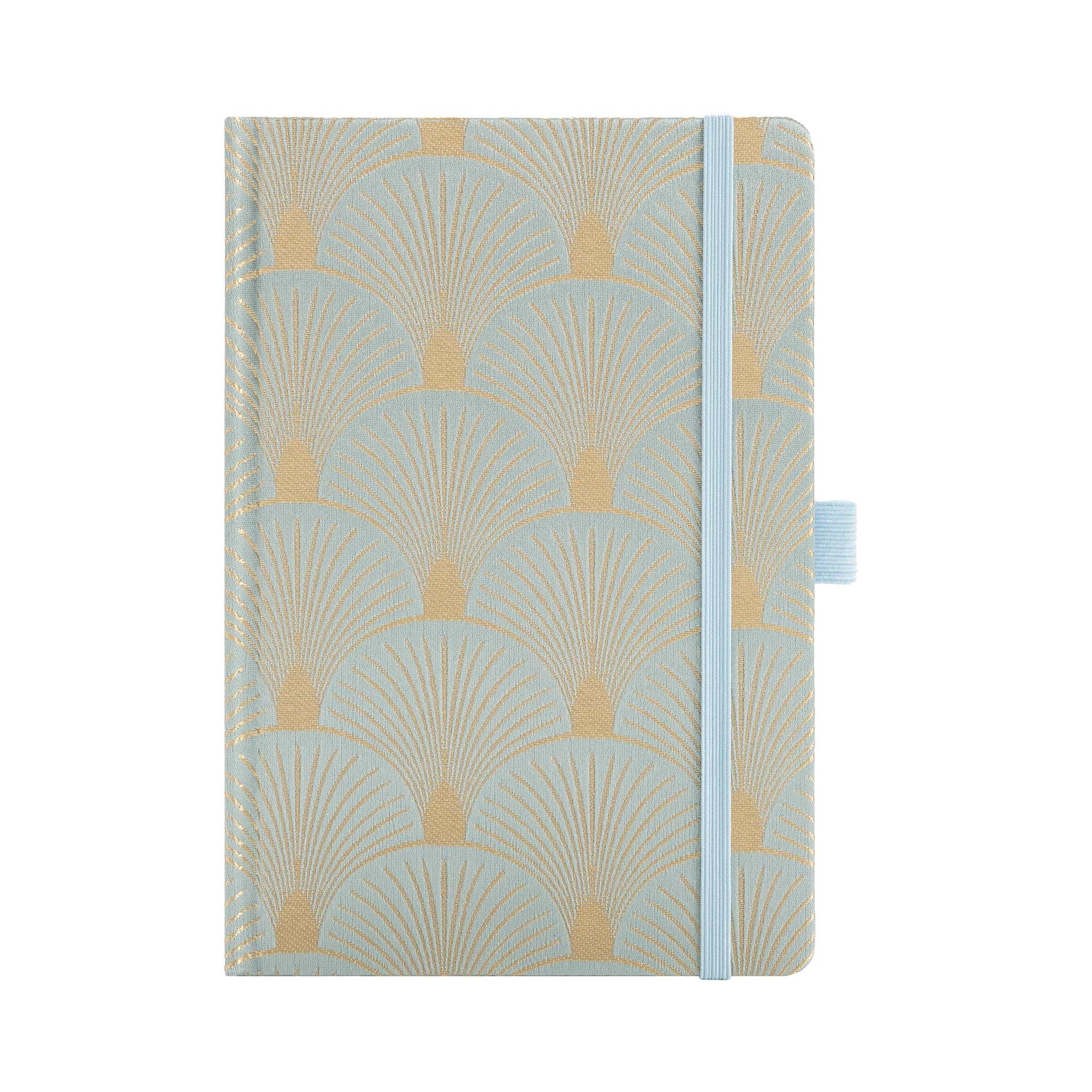 A5 woven fabric notebook with a scalloped embroidery pattern in light green and gold, standing upright on a white background with a matching light blue elastic band.