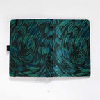 Flat lay of the black and green embroidered fabric cover opened completely