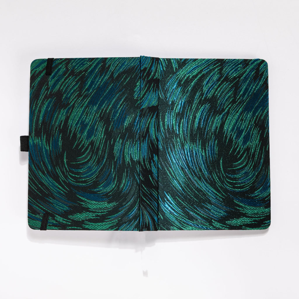 Flat lay of the black and green embroidered fabric cover opened completely