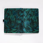 Flat lay of the black and green embroidered fabric cover opened completely