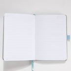 Open A5 notebook showing the 100gsm lined paper interior with date headers and ribbon bookmark