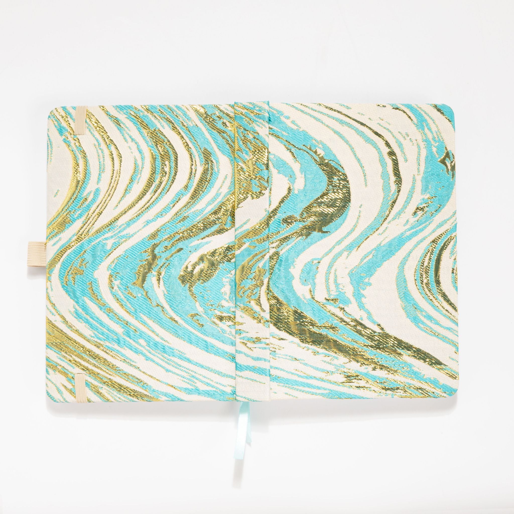 Flat lay of the light blue and gold marble fabric cover opened completely, showing the inner lining and ribbon bookmark