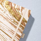 Close-up of gold marble metallic foil fabric cover texture