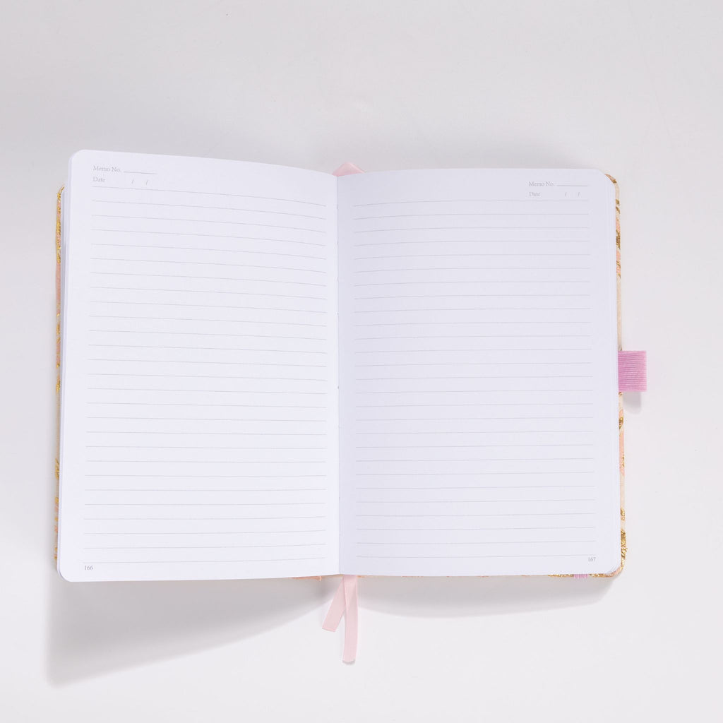 Open A5 notebook showing the 100gsm lined paper interior with pink ribbon bookmark