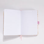 Open A5 notebook showing the 100gsm lined paper interior with pink ribbon bookmark