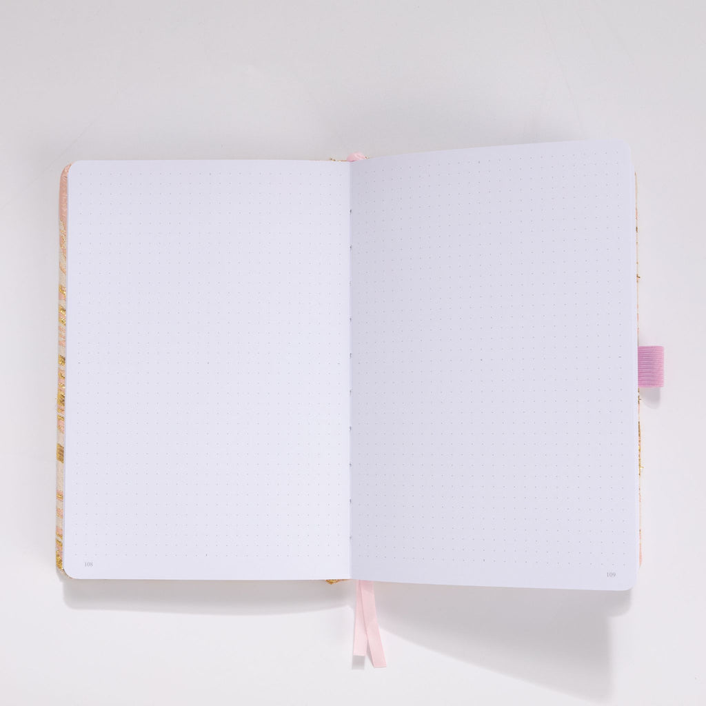 Open A5 journal showing the thick 160gsm dot grid interior pages