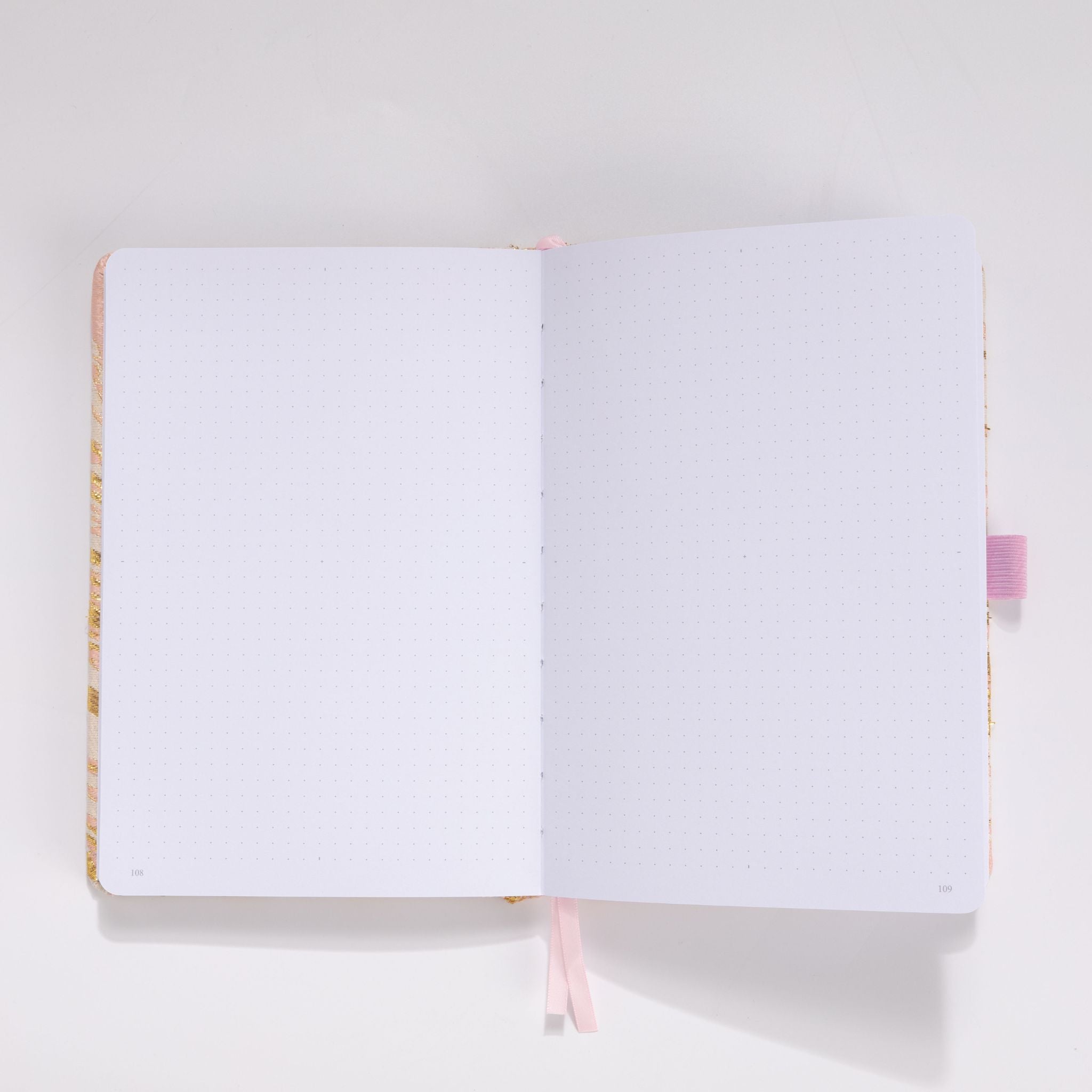 Open A5 journal showing the thick 160gsm dot grid interior pages