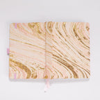 Flat lay of the blush pink and gold marble woven fabric cover opened completely