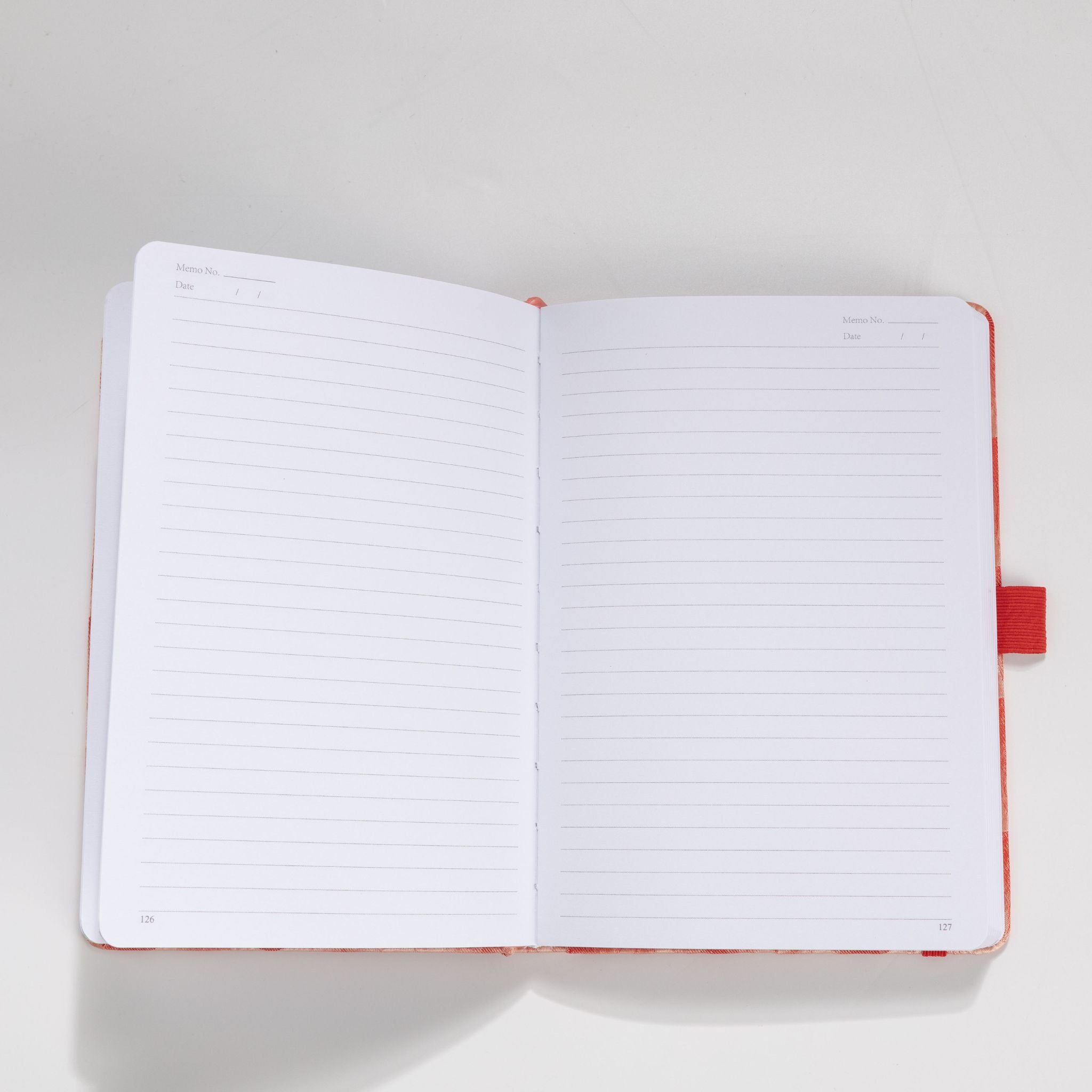 Open A5 notebook showing the 100gsm lined paper interior with date headers
