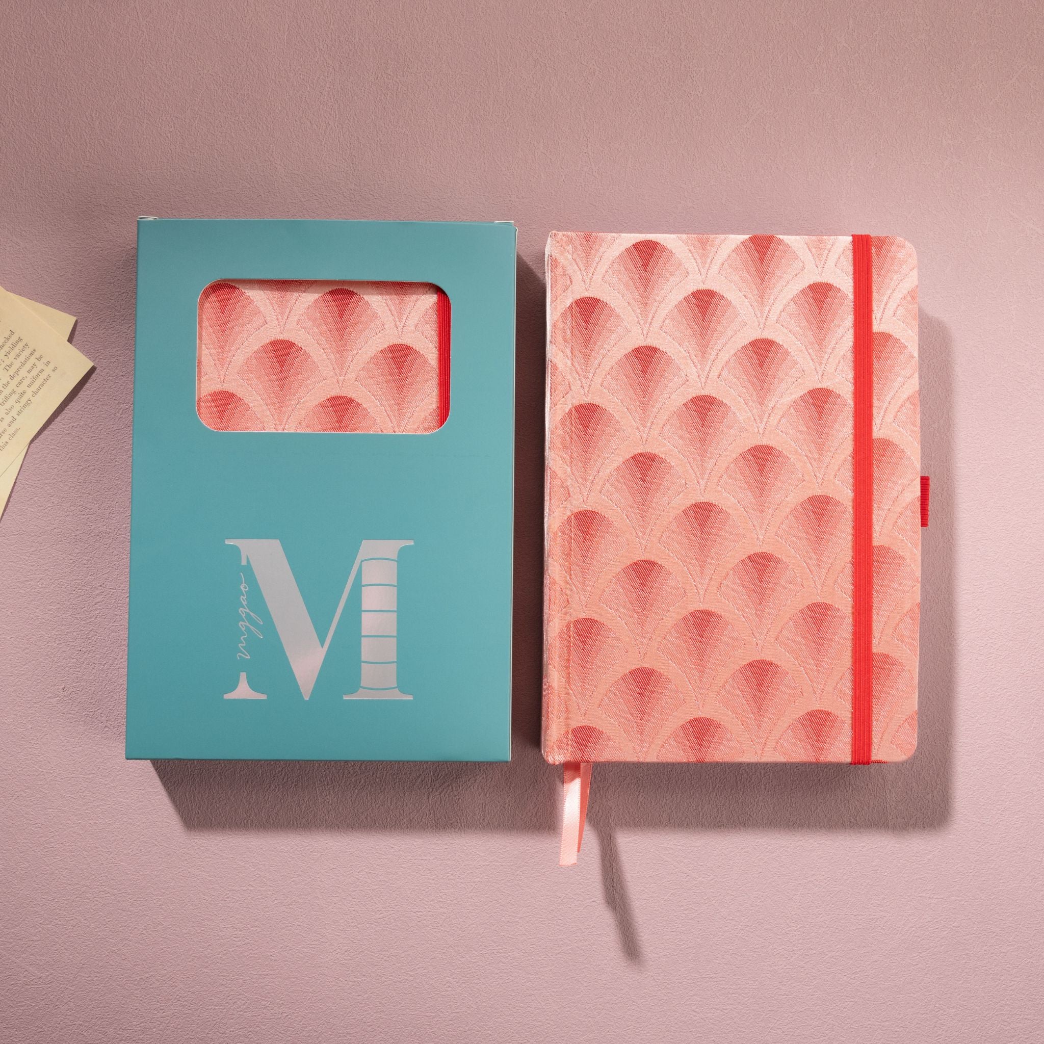 Red scalloped fabric notebook displayed next to its signature light blue window-cut gift box
