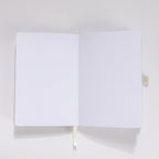 Open A5 journal showing the 160gsm dot grid interior pages with white ribbon bookmark