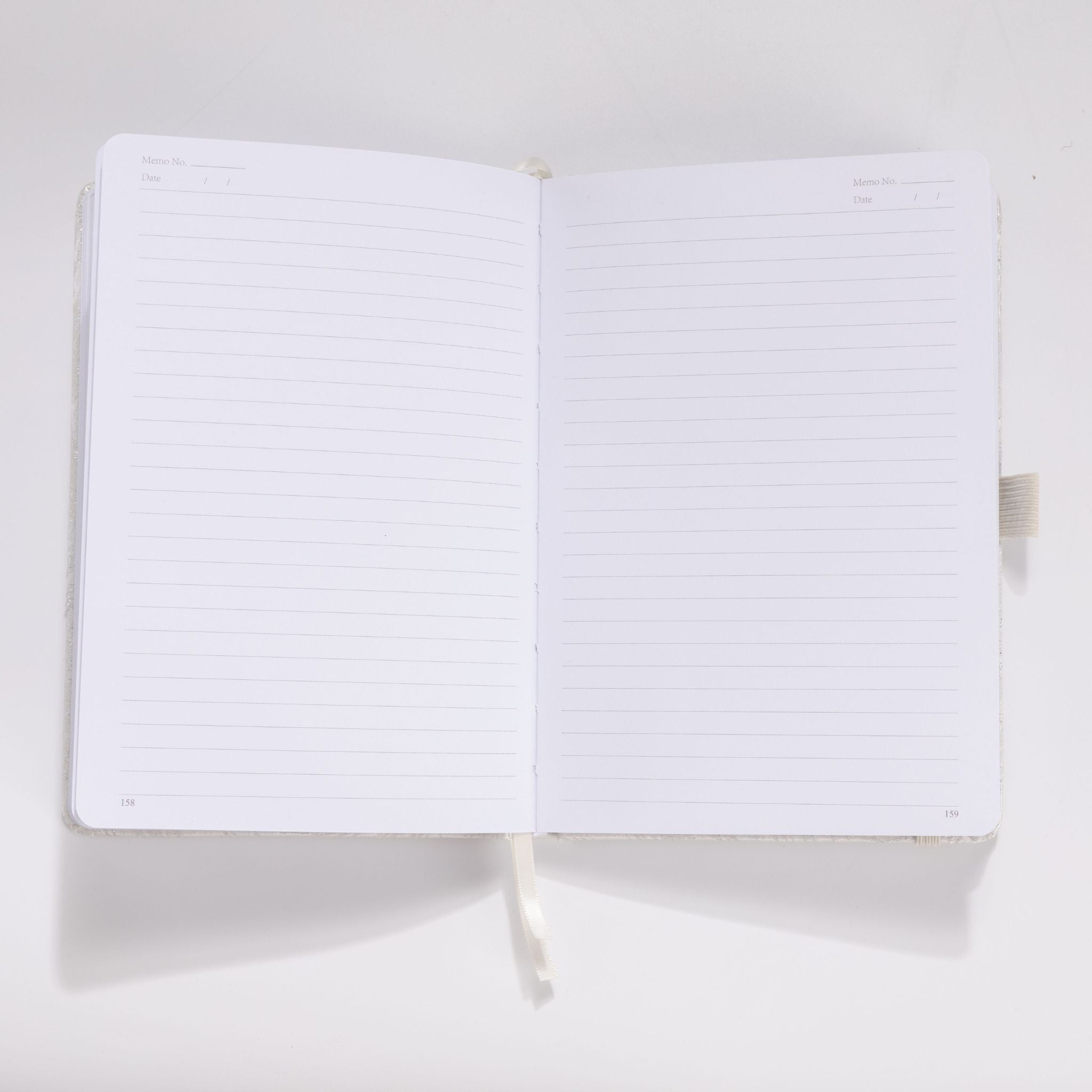 Open A5 notebook showing the 100gsm lined paper interior with date headers