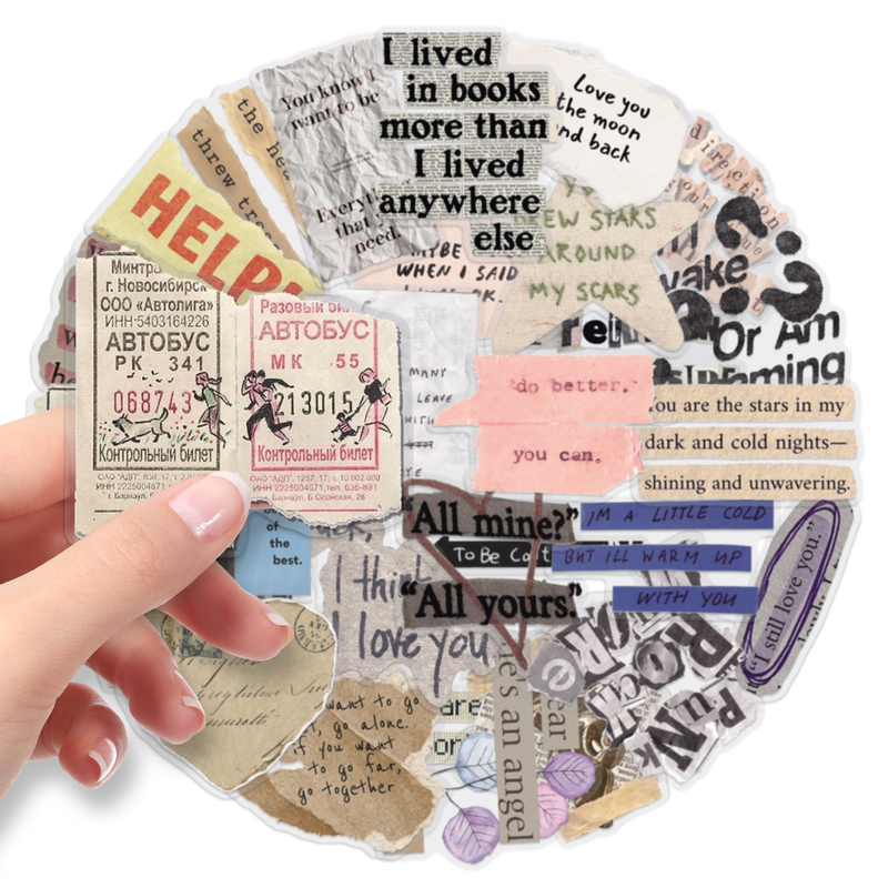 A hand holds a circular collage of vintage-style paper stickers and text decals in assorted colors, including beige, pink, blue, black, and white, on a plain white background.
