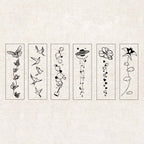 A flat-lay of 6 stamped line-art designs from the Wind-Kissed Poems set, each featuring a vertical layout of butterflies, flying birds, bubble trails, stars and moons, flowers with hearts, and clouds with a windmill, displayed on a textured background.