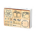 A white storage box containing 17 wooden daily planner stamps, featuring a to-do list frame, weather icons, expression faces, date headers, and a clock face, displayed on a clean white background.